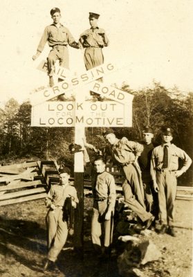 Cadets pose in a funny picture at a railroad crossing sign.