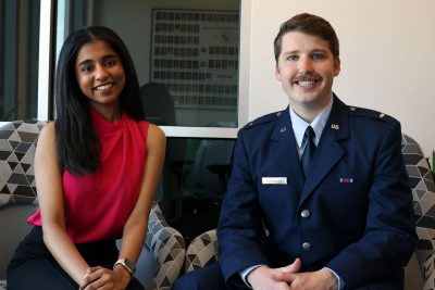 Monica Shanmugan and Patrick Corrigan seated.