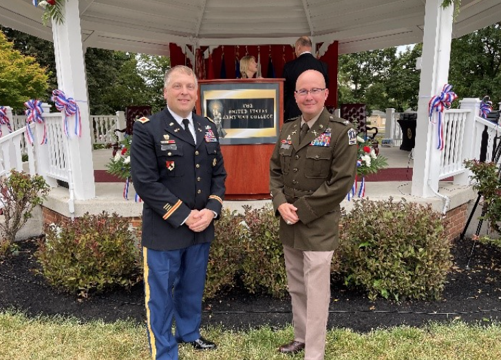 Jones and Talmadge stand in uniform by a gazebo at a ceremony