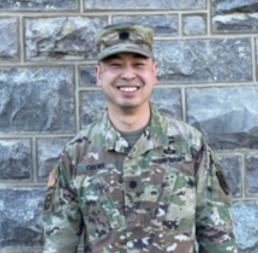 Cheng stands in uniform smiling in front of Hokie Stone