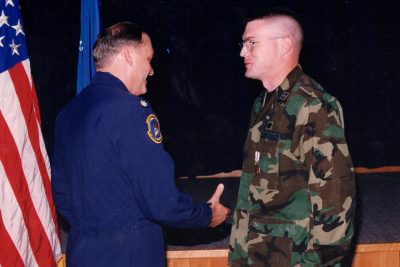 Lt. Col. Jim Mackin presents Dorminey with an end of tour medal.