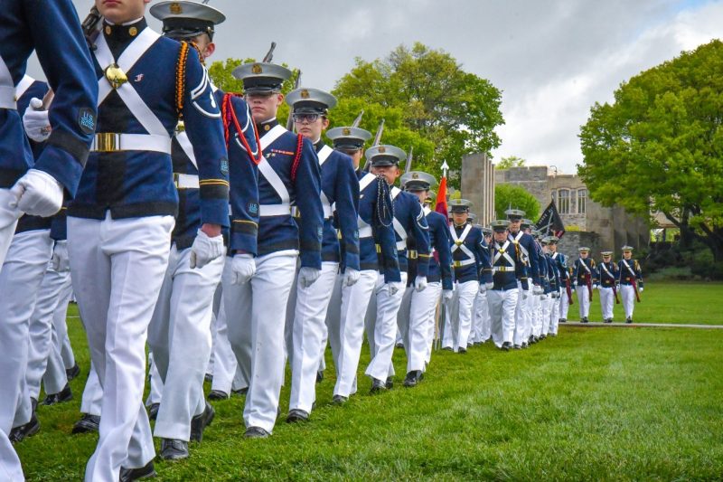 Cadets march in dress uniforms on the Drillfield during a pass in review in April 2023