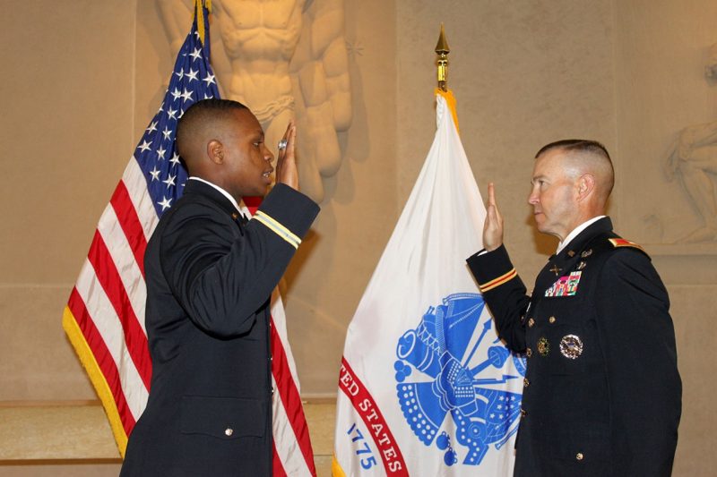 Col. Kevin Milton, the Army ROTC professor of military sicence, at right, administers the oath of office to Joseph Cowen ‘17, one of 69 Virginia Tech Army ROTC cadets who commissioned as second lieutenants this academic year.