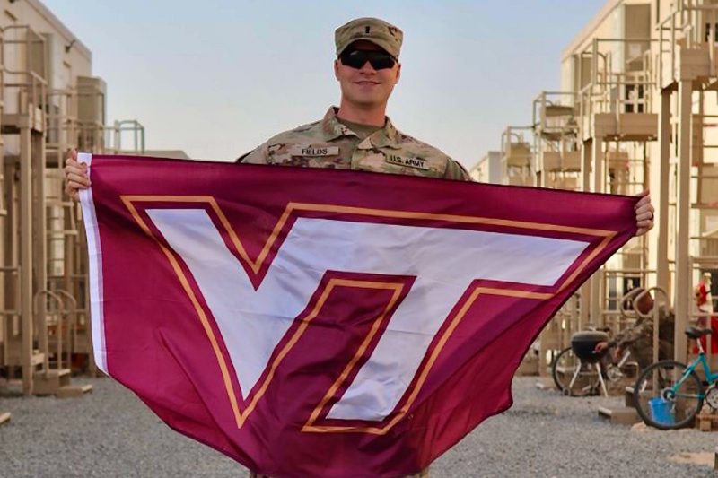 1st Lt. Patrick Fields holds a Virginia Tech flag in Kuwait.
