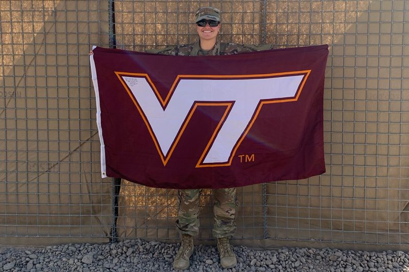 Army 2nd Lt. Catie Fields holds a Virginia Tech flag.