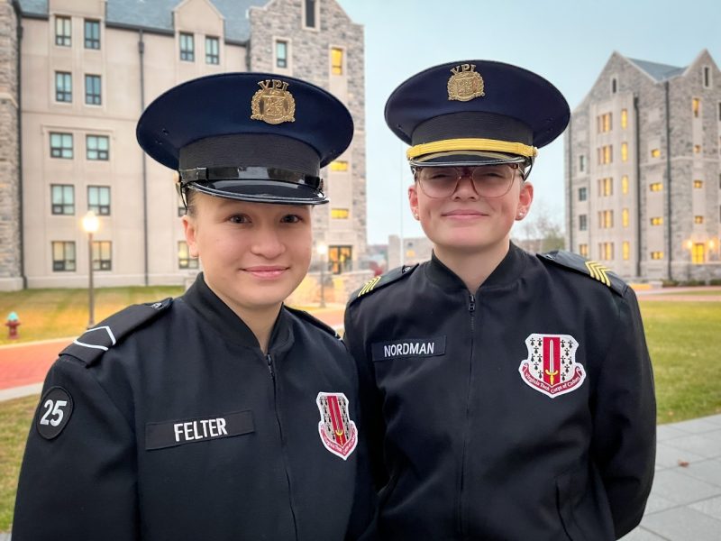 Cadet Felter and Cadet Nordman stand in uniform smiling on Upper Quad.