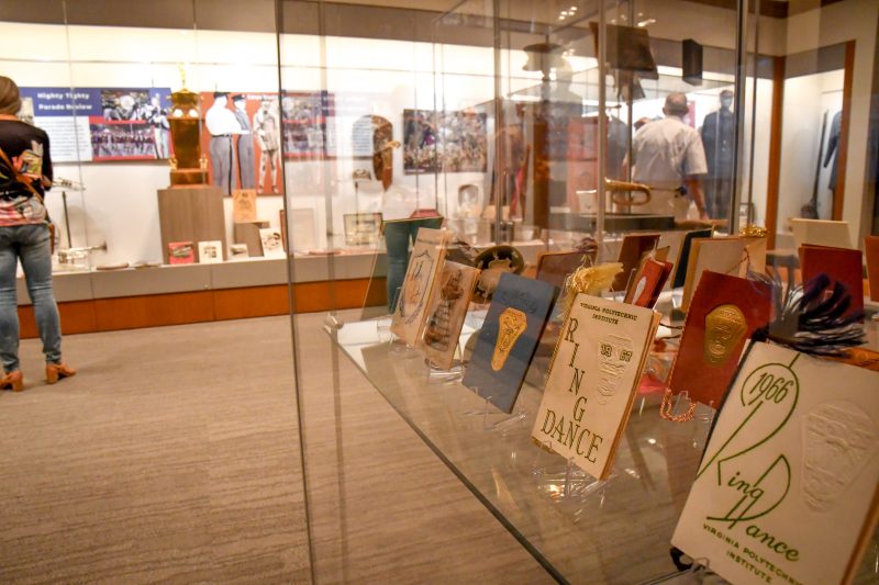 A display case show programs from Ring Dance. Another long display is in the background.