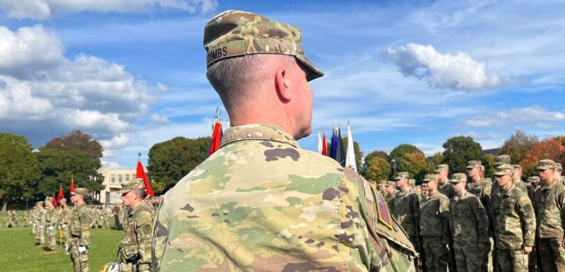 Sgt. Maj. Combs faces away from the camera and observes cadets in formation