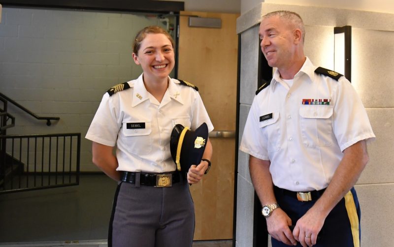 Sgt. Maj. Combs stands with a smiling cadets inside the residence hall.