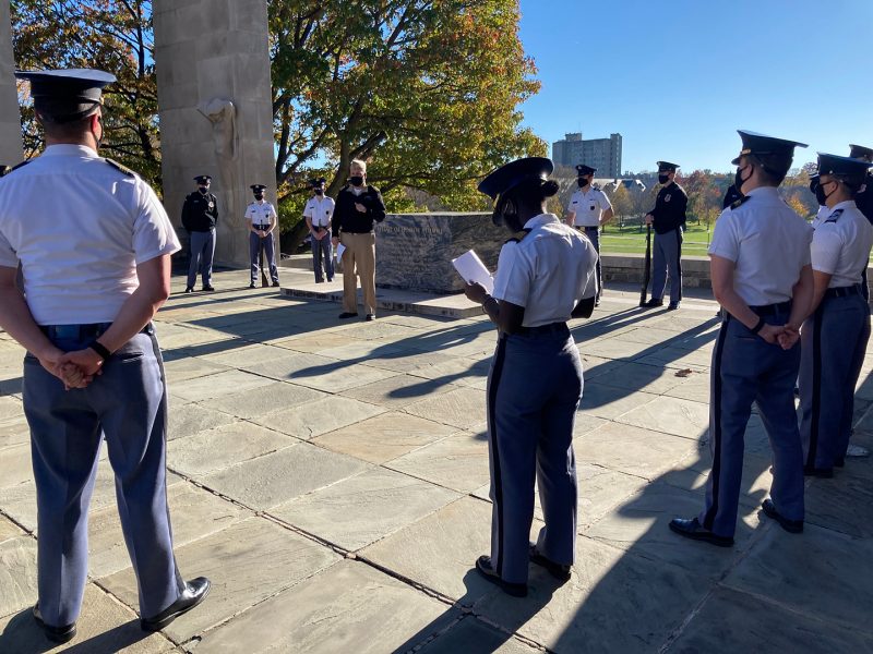 Jamie McGrath (center) works with cadets during a rehearsal for a ceremony at the Pylons this fall.