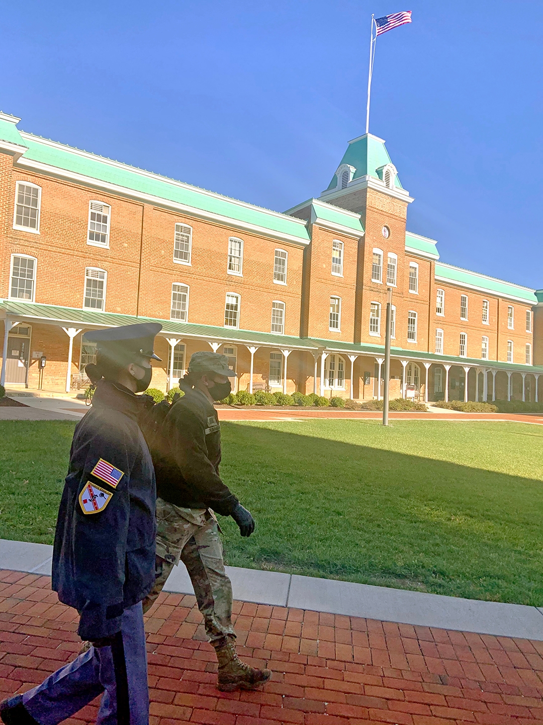 Cadets Devin Scofield ‘22 (left) and Darby Dummer ’21 walk past Lane Hall. 