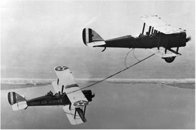 Two planes refuel in midair.