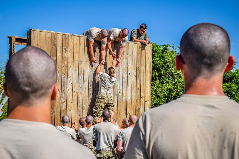 First-year cadets figure out the team wall at the Corps’ obstacle course in 2017. 