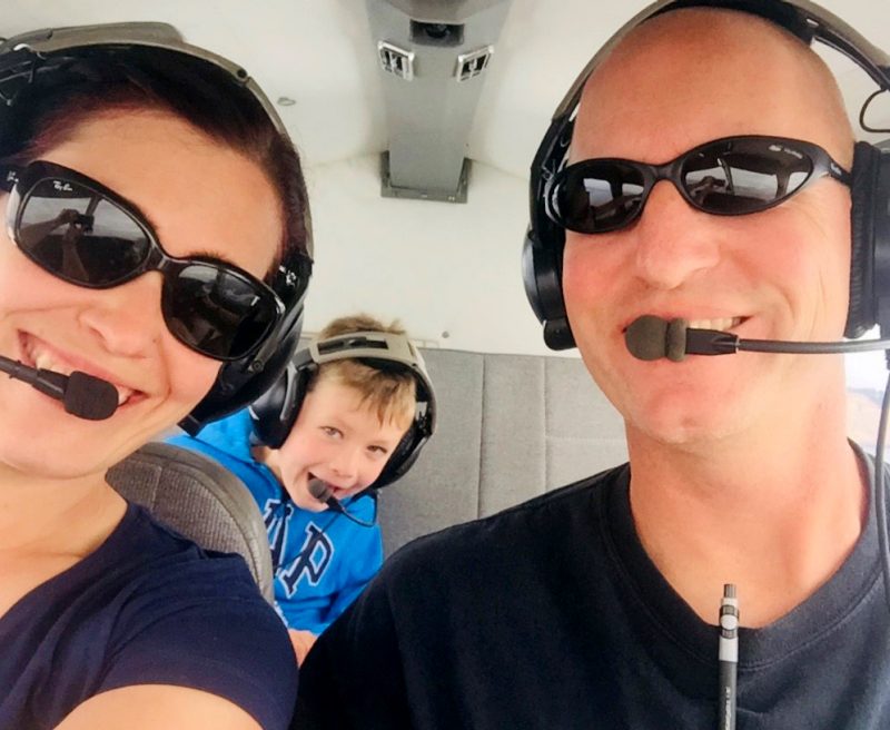From left, Rebecca, William, and Jay Borella ride in a small plane.