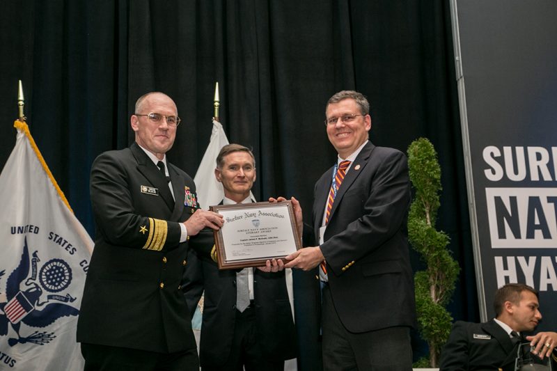 Capt. Jamie McGrath (at right) receives an award