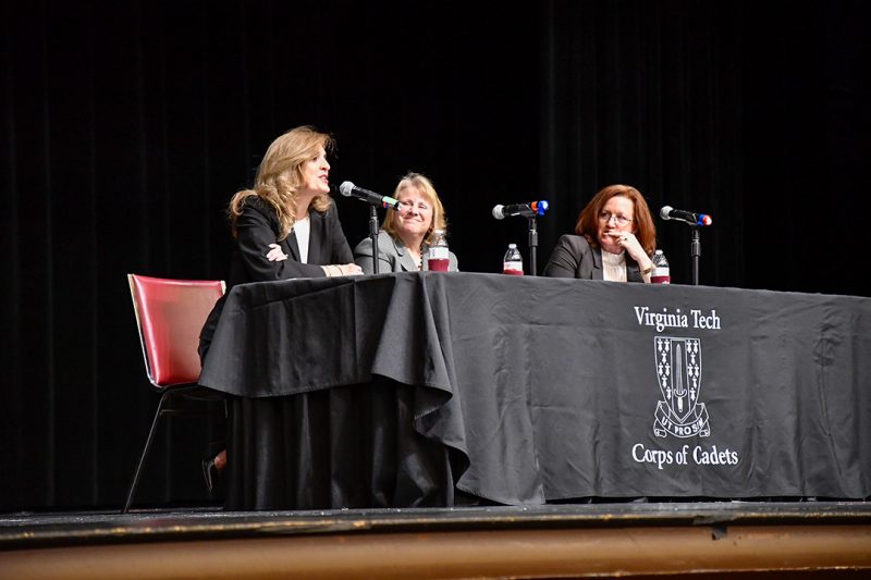 From left: Jeannine James ’87, Jill Boward ’87 and Christy Nolta ’85 talk while seated on a stage.