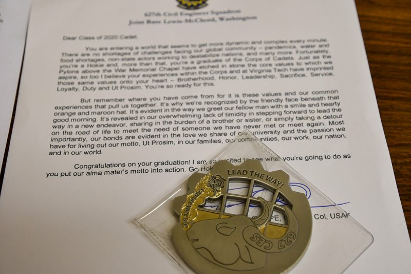 A letter to a cadet includes a uniquely shaped challenge coin.