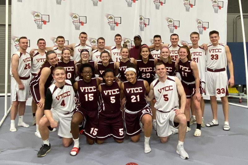 The Corps' men's and women's basketball teams pose for a group photo.