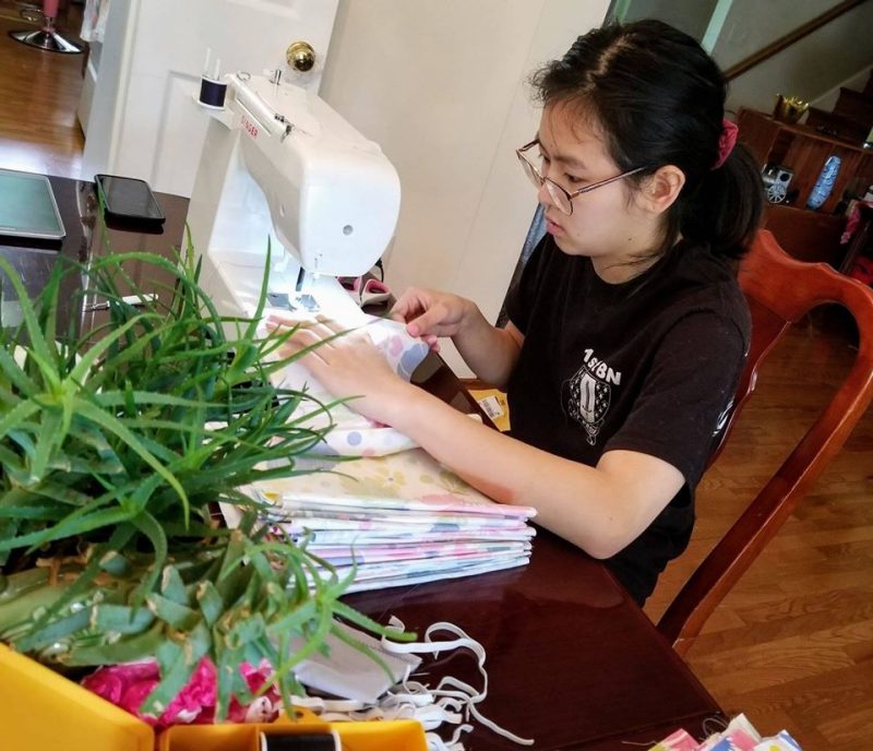 While taking her classes at home, Cadet Vivian To ’23 sews face masks to donate 