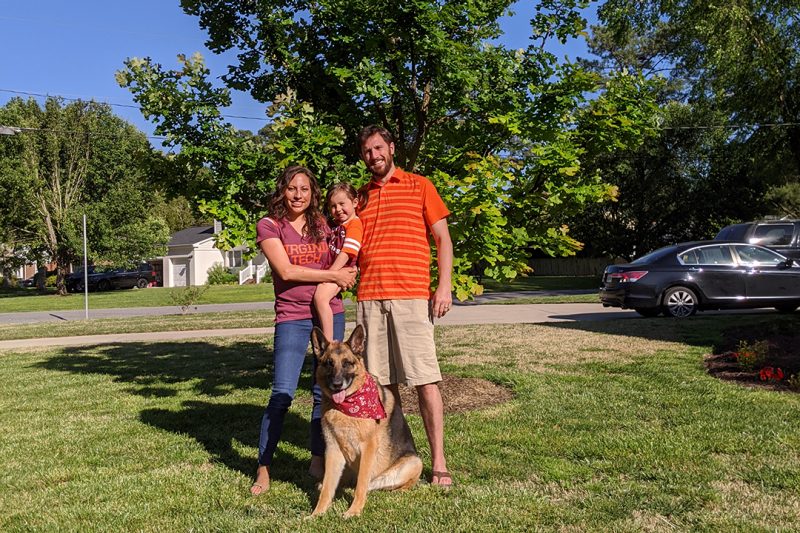 Carissa, Madelyn, and John Hawley with their dog, Django, in front of their War Memorial oak at their old home. 