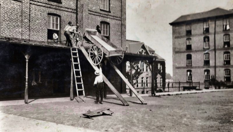 A professor directs the retrieval of his buggy that cadets put on the Barracks No. 1 porch roof.