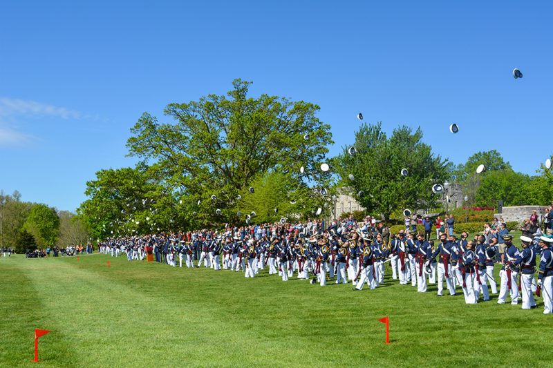 Seniors throw their covers into the air at the end of the Change of Command Parade. 