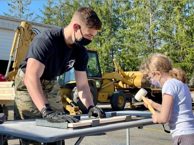 Cadets for a Cause Finance Officer Cadet Bobby Munn ’23 (at left) works with Gwen Herzog (at right) to prepare wood.