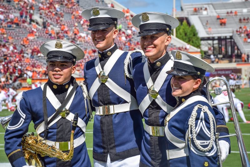 Members of the Highty-Tighties pose for a picture in Lane Stadium.