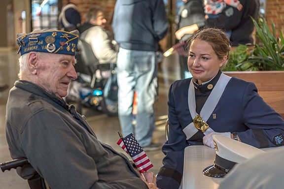 A veteran talks with a cadet.