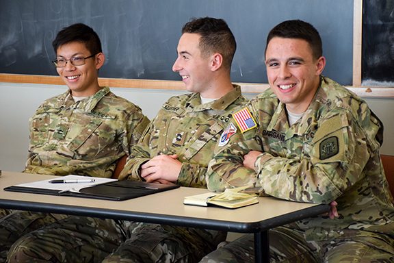 Three cadets sit in a classroom