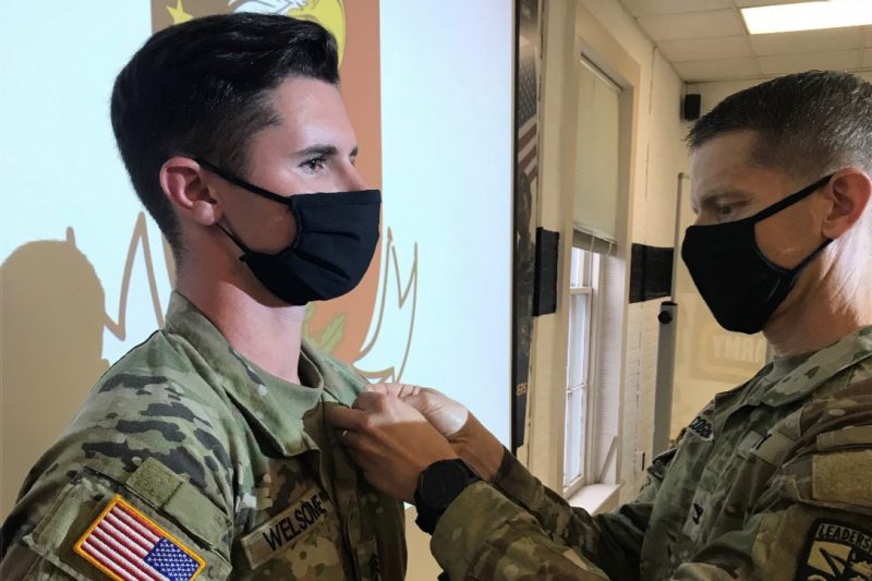 Col. Jamie Cogbill, at right, pins the Bronze Cross Award on Cadet Jack Welsome.