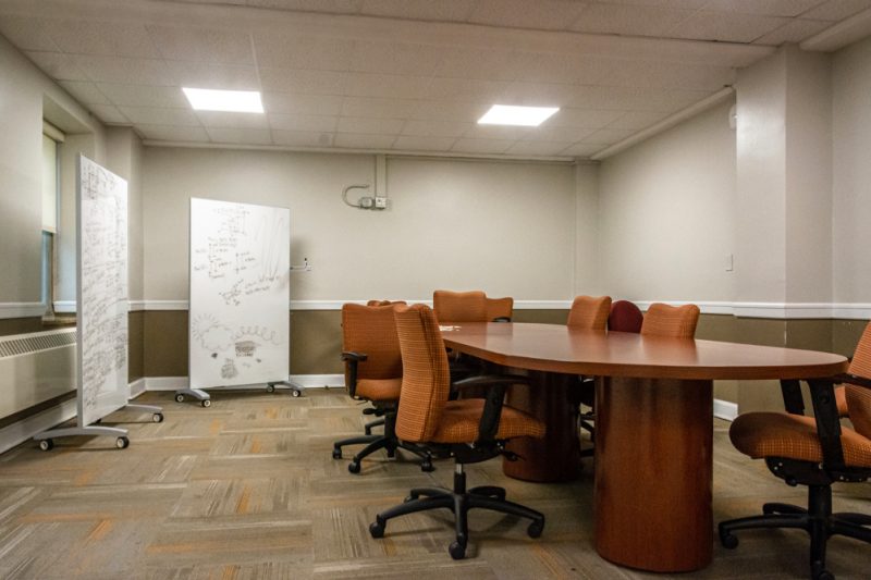 A larger lounge in Eggleston Hall has a conference table and whiteboards.