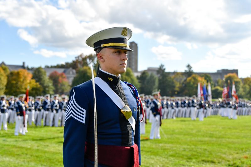 A cadet stands in front of the regiment during a military parade.